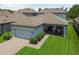 An aerial view showcasing the home's manicured front lawn, patio, and attached two-car garage at 12272 Rangeland Blvd, Odessa, FL 33556