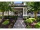 Inviting front porch with rocking chairs, a porch swing, and decorative wreath, creating a welcoming entrance at 12272 Rangeland Blvd, Odessa, FL 33556