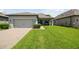 Charming one-story home with a well-manicured lawn and an attached two-car garage at 12272 Rangeland Blvd, Odessa, FL 33556