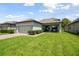 Charming one-story home with a well-manicured lawn and an attached two-car garage at 12272 Rangeland Blvd, Odessa, FL 33556