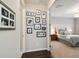 Hallway with dark wood floors leading to a bedroom with patterned bedding and decor at 12272 Rangeland Blvd, Odessa, FL 33556