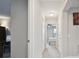 Bright hallway leading to bedrooms, showcasing neutral walls and carpet at 12272 Rangeland Blvd, Odessa, FL 33556