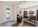 Well-appointed home office with dark hardwood floors, built-in bookshelves, and a cozy leather chair at 12272 Rangeland Blvd, Odessa, FL 33556