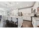 Bright kitchen featuring a large island with bar seating, stainless steel appliances, and stylish pendant lighting at 12272 Rangeland Blvd, Odessa, FL 33556