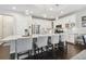 Lovely kitchen with island and granite counters with bar stool seating, stainless appliances, and white cabinets at 12272 Rangeland Blvd, Odessa, FL 33556