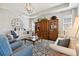 Spacious living area with a chandelier, a wooden hutch, comfortable seating, and large windows at 12272 Rangeland Blvd, Odessa, FL 33556