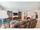 Spacious living room featuring comfortable seating, built-in bookshelves, and neutral décor at 12272 Rangeland Blvd, Odessa, FL 33556