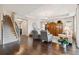Inviting living room with hardwood floors, staircase, and elegant decor including a large wooden entertainment center at 12272 Rangeland Blvd, Odessa, FL 33556