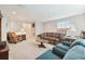 Comfortable living room with a cozy armchair, decorative furniture, and a view of the hallway at 12272 Rangeland Blvd, Odessa, FL 33556