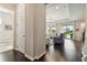 Inviting living space showcasing hardwood floors and open access to a powder room and living room at 12272 Rangeland Blvd, Odessa, FL 33556