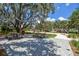 A picturesque park featuring picnic tables, a playground, and scenic walking paths under the shade of mature trees at 12272 Rangeland Blvd, Odessa, FL 33556
