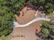 A playground set amidst lush greenery with winding paths, perfect for outdoor activities and Gathering fun at 12272 Rangeland Blvd, Odessa, FL 33556
