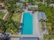 A community pool with palm trees, modern architecture, and a spacious deck for lounging and socializing with neighbors at 12272 Rangeland Blvd, Odessa, FL 33556