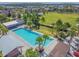 A sparkling community pool with sun loungers surrounded by palm trees and manicured lawns, perfect for relaxation at 12272 Rangeland Blvd, Odessa, FL 33556