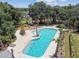An inviting community pool with clear waters, lush landscaping, and lounge chairs, offering a perfect spot for relaxation at 12272 Rangeland Blvd, Odessa, FL 33556