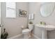 Cozy powder room featuring modern fixtures, a pedestal sink, and stylish decor at 12272 Rangeland Blvd, Odessa, FL 33556