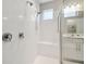 Modern glass enclosed shower with double shower heads, bench and vanity at 12272 Rangeland Blvd, Odessa, FL 33556