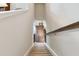 View down carpeted stairs with wood railing, leading to the lower level of the home at 12272 Rangeland Blvd, Odessa, FL 33556