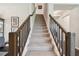 Carpeted stairway with stained wood banister, leading to the upper level of the home at 12272 Rangeland Blvd, Odessa, FL 33556