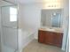 Bright bathroom featuring a separate glass shower, tub, and vanity with a large mirror at 12431 White Bluff Rd, Hudson, FL 34669
