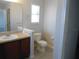 Clean bathroom featuring a single sink vanity, tile flooring, and a well-lit mirror at 12431 White Bluff Rd, Hudson, FL 34669