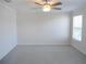 Large bedroom with carpet flooring, ceiling fan and natural light from a large window at 12431 White Bluff Rd, Hudson, FL 34669