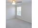 Cozy bedroom with plush carpet flooring, a ceiling fan and a bright window for natural lighting at 12431 White Bluff Rd, Hudson, FL 34669