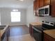 Eat-in kitchen featuring stainless steel appliances, countertops and breakfast area with window views at 12431 White Bluff Rd, Hudson, FL 34669