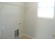 Laundry room featuring tile floors, a shelf, hookups for a washer and dryer, and a window at 12431 White Bluff Rd, Hudson, FL 34669