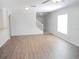 Spacious living room with hardwood floors, staircase and large windows for natural lighting at 12431 White Bluff Rd, Hudson, FL 34669