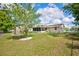 A view of the expansive backyard with a shed and screened-in patio, perfect for outdoor enjoyment at 12478 Prescott St, Spring Hill, FL 34609