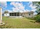 Large backyard with a shed, screened in porch, and white rock accents along the sides of the house at 12478 Prescott St, Spring Hill, FL 34609