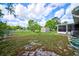 Large grassy backyard with a storage shed and a screened in porch, great for entertaining at 12478 Prescott St, Spring Hill, FL 34609