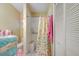 Bright bathroom featuring a walk-in shower with a seat and a butterfly-themed shower curtain at 12478 Prescott St, Spring Hill, FL 34609