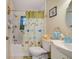 Bathroom featuring a tub/shower combo with a butterfly shower curtain and a white vanity at 12478 Prescott St, Spring Hill, FL 34609
