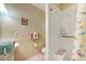 Bathroom features a sink, toilet, and walk-in shower with a built-in seat and safety bar at 12478 Prescott St, Spring Hill, FL 34609