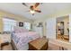Bright bedroom featuring a large bed with patterned linens and a wooden trunk at the foot at 12478 Prescott St, Spring Hill, FL 34609
