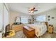 Bedroom featuring a bed with patterned bedding, a ceiling fan, and a large dresser at 12478 Prescott St, Spring Hill, FL 34609