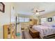 Comfortable bedroom with wooden accents, featuring light-colored walls, ceiling fan and a calming ambiance at 12478 Prescott St, Spring Hill, FL 34609
