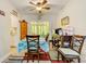 Dining area with a table, chairs, and view of the bright, sunlit porch with furniture at 12478 Prescott St, Spring Hill, FL 34609