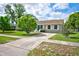 Well-maintained home with a lovely front lawn, established trees, and a cozy front porch at 12478 Prescott St, Spring Hill, FL 34609
