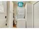 Efficient laundry area features a stacked washer and dryer unit and additional storage cabinets at 12478 Prescott St, Spring Hill, FL 34609