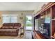 Bright living room featuring an inviting door and a leather sofa at 12478 Prescott St, Spring Hill, FL 34609