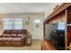 Bright living room featuring an inviting door and a leather sofa at 12478 Prescott St, Spring Hill, FL 34609