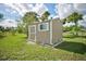 Storage shed in the backyard with a garden bed and flowers planted along the perimeter at 12478 Prescott St, Spring Hill, FL 34609
