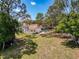 Lovely home with a refreshing screened pool, surrounded by mature trees and a spacious green lawn at 1280 Thornton Ct, Spring Hill, FL 34608