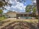 A spacious backyard featuring a private screened pool at 1280 Thornton Ct, Spring Hill, FL 34608