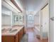 Large bathroom features a double sink vanity, a soaking tub, an arched window, and tile flooring at 1280 Thornton Ct, Spring Hill, FL 34608