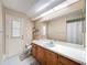 Bright bathroom featuring a spacious vanity and a large mirror, complemented by tile flooring at 1280 Thornton Ct, Spring Hill, FL 34608