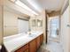 Bathroom featuring a sink with full mirror and a doorway into another room at 1280 Thornton Ct, Spring Hill, FL 34608